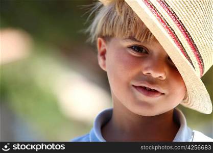 Little boy wearing straw hat