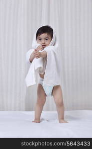 Little boy with a towel wrapped around him