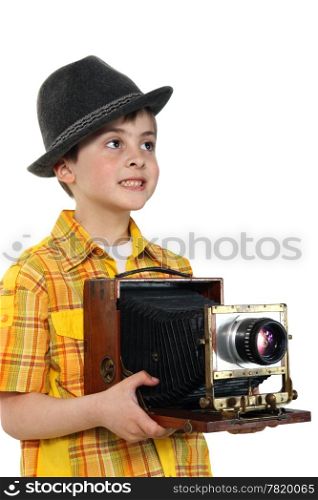 Little boy with an old camera on the white background