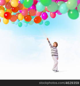 Little boy with balloons. Little cute boy playing with bunch of colorful balloons