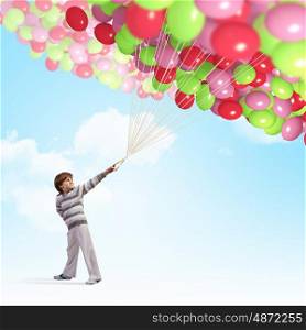Little boy with balloons. Little cute boy playing with bunch of colorful balloons