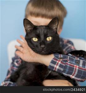 little boy with black cat