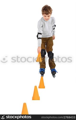 little boy with cone in hand rollerblading near orange cones looking down isolated on white