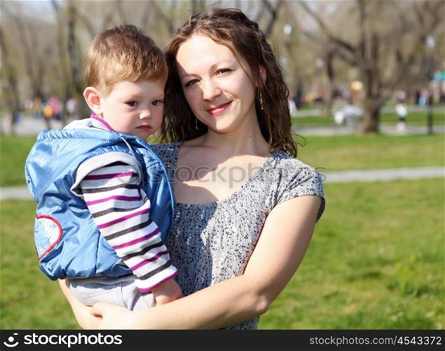 little boy with his mother in spring park