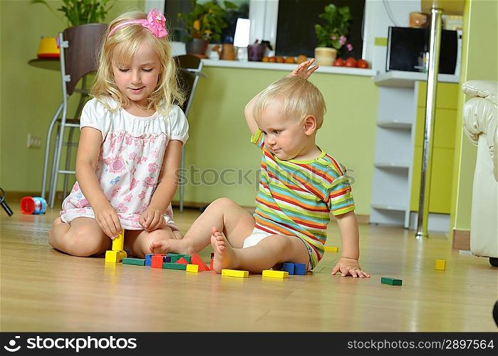 little boy with his sister playing at home