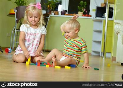 little boy with his sister playing at home