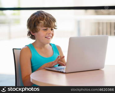 Little boy with laptop in library. Little boy with laptop