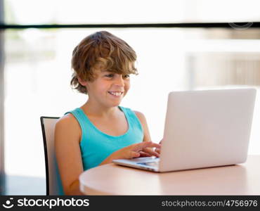 Little boy with laptop in library. Little boy with laptop