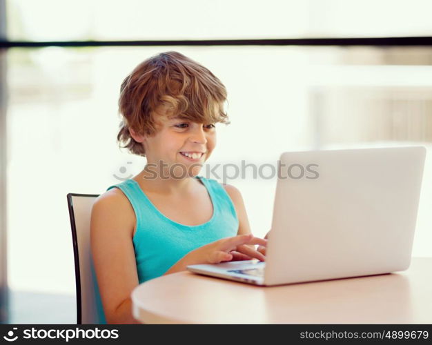 Little boy with laptop in library. Little boy with laptop