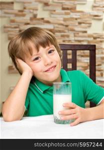 Little boy with milk at the table