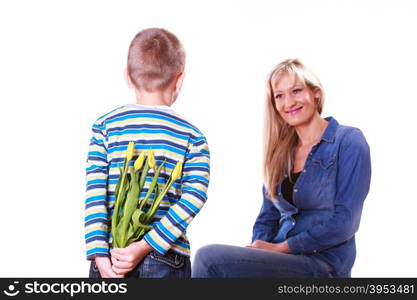 Little boy with mother hold flowers behind back.. Special occasions holiday and mother day. Young boy prepare surprise gift flowers hold tulips behind back mother sit smiling.