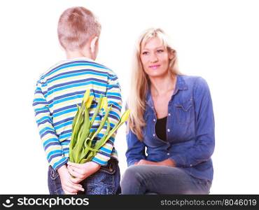 Little boy with mother hold flowers behind back.. Special occasions holiday and mother day. Young boy prepare surprise gift flowers hold tulips behind back mother sit smiling.