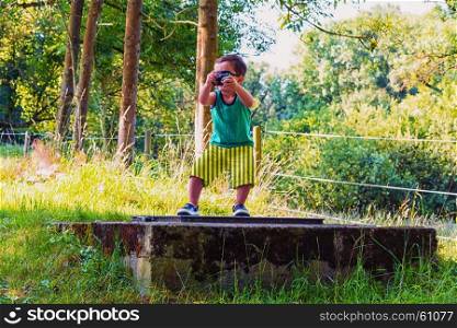 Little boy with old digital camera