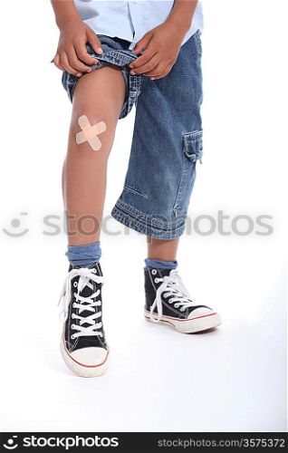 Little boy with plaster on his knee