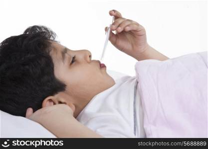 Little boy with thermometer in his mouth