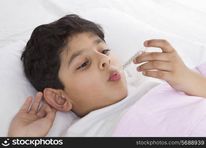 Little boy with thermometer in his mouth