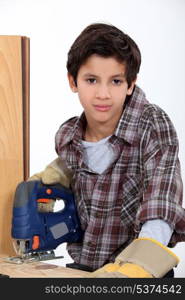 Little boy with wood saw