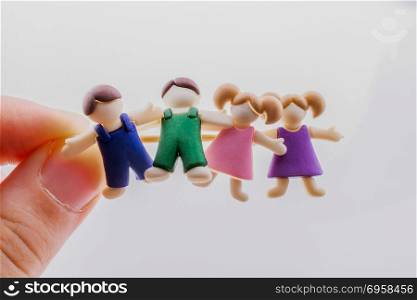Little boys and girls kid figurines in hand. Little colorful boys and girls kid figurines in hand