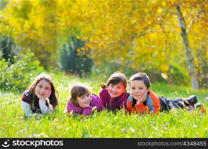 Little boys and girls laying down on grass