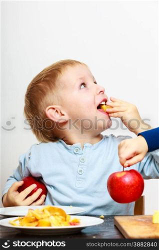 Little boys children brothers preschooler peeling fruit apple eating cooking at home. Happy childhood.