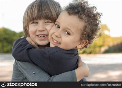 little boys outdoors hugging
