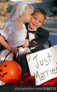 Little Bride Giving Her Groom A Trick-Or-Treat Kiss