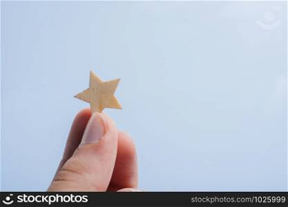 Little bright stars in a on hand on gray background