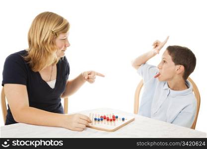 Little brother driving his teenage sister crazy while they play a board game. Isolated on white.