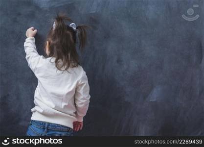 little brunette girl writing wall