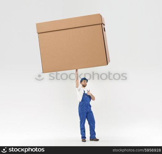 Little builder holding a huge paper box