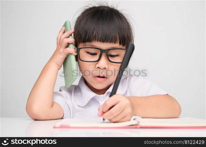 Little business woman with laptop working in office while talking on the phone Children and business concepts