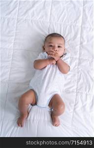 little cheerful baby on a bed