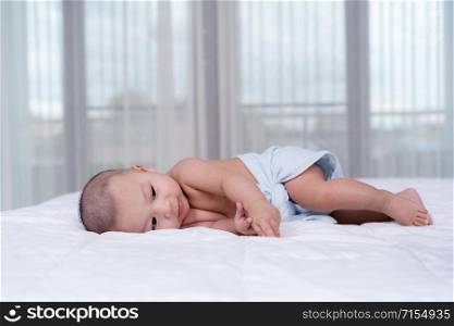 little cheerful baby on a bed