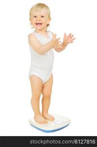 Little child on scales isolated