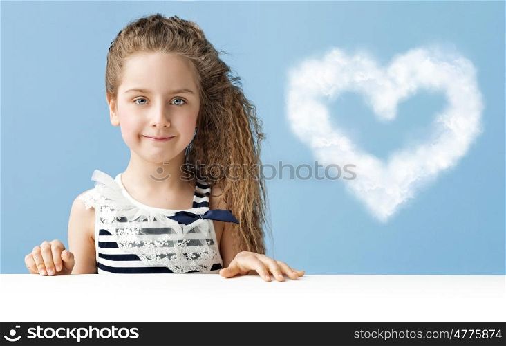 Little child with a heart-shaped cloud