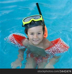 Little child with diving goggles and snorkel swimming in the water