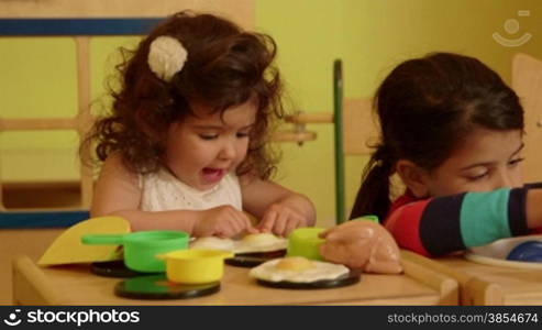 Little children, baby, playing in kindergarten, school. Little girls, sisters, happy female friends playing with toys in preschool. Recreation and education. 5of15