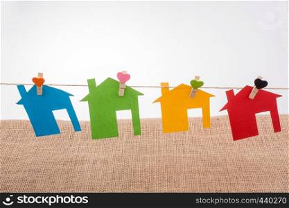 Little color paper houses attached to a string with a heart clip