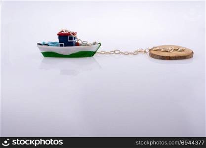Little colorful model boat with chains on white background