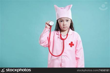 Little cute asian girl wear medical suit ,kid dream become nurse or doctor concept .