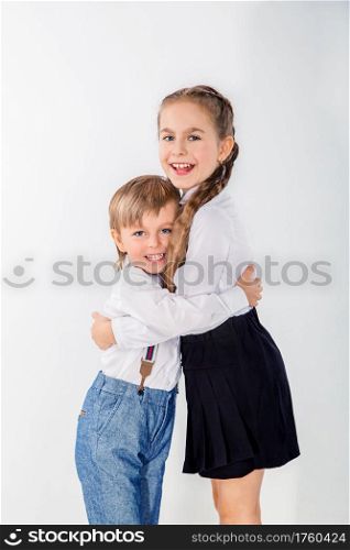 Little cute boy and girl hugging playing on white background, lifestyle people concept.. Little cute boy and girl hugging playing on white background.