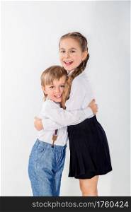 Little cute boy and girl hugging playing on white background, lifestyle people concept.. Little cute boy and girl hugging playing on white background.