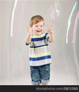 Little cute boy playing a soap bubbles