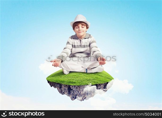 Little cute boy relaxing. Image of little boy sitting on cloud and meditating