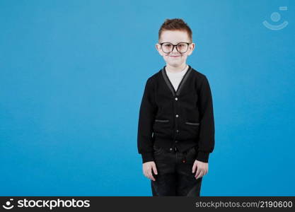 Little cute boy with glasses is smiling and having fun isolated on grey background. happy childhood. copy space.. Little cute boy with glasses is smiling and having fun isolated on grey background. happy childhood. copy space