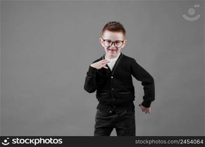 Little cute boy with glasses is smiling and having fun isolated on grey background. happy childhood. copy space.. Little cute boy with glasses is smiling and having fun isolated on grey background. happy childhood. copy space
