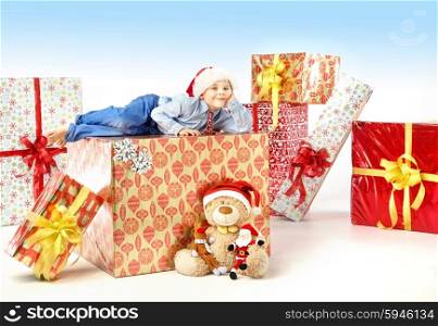 Little cute boy with plenty of presents