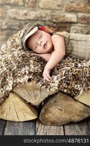 Little cute child sleepieng on the piece of wood