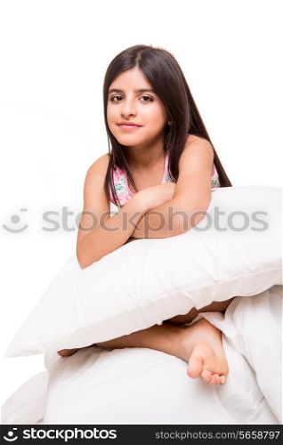 Little cute girl grabbing pillow over white