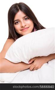 Little cute girl grabbing pillow over white
